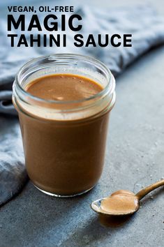 a jar of peanut butter next to a spoon