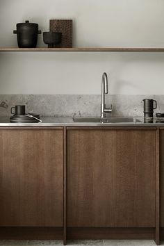 a kitchen with wooden cabinets and stainless steel sinks