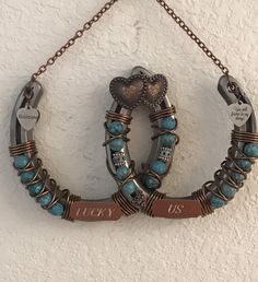 two pieces of jewelry hanging on a wall