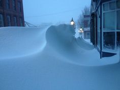 the snow is piled up on the side of the building