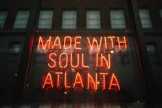 a neon sign with the words made with soul in atlanta on it's side