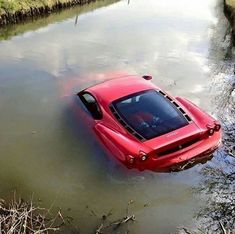 a red car is submerged in the water