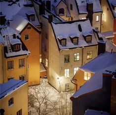 an aerial view of houses in the snow at night