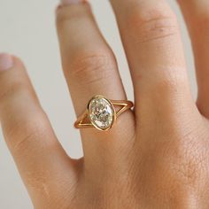 a woman's hand with a ring on it and a diamond in the middle