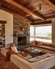 a living room filled with furniture and a fire place in the middle of a room