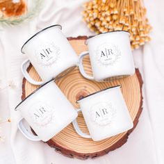 four white coffee mugs sitting on top of a wooden tray