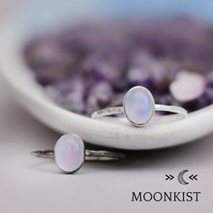 This lovely Periwinkle Blue Chalcedony Ring in Sterling Silver features an 8 mm x 6 mm oval natural Blue Chalcedony cabochon that has been securely set in a highly polished fine silver bezel. The band is made of a sturdy round Sterling Silver wire that has a hammered texture around the entire band. Sterling Silver Wire, Sterling Silver Plate, 8 x 6 mm Oval Gemstone Dimensions - Widest point - 8 mm, Band - 1.5 mm Includes free resizing and 1 year warranty Dainty Oval Cabochon Ring, Adjustable Oval Moonstone Ring In White Gold, Dainty Handmade Oval Moonstone Ring, Oval Stackable Moonstone Ring Gift, Handmade Oval White Gold Moonstone Ring, Oval Cabochon Stackable Jewelry As A Gift, Oval Cabochon Stackable Jewelry Gift, Oval Cabochon Stackable Jewelry For Gifts, Minimalist Oval Moonstone Ring With Natural Stones