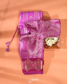 A Banarasi art silk saree, featuring a harmonious blend of mulberry pink and maroon hues. The baby blue section is embellished with vertical zari stripes alternated by zari buttis throughout, adding a distinct accent to the overall look. The saree is further enhanced by a contrasting border adorned with zari floral work, highlighted with multicolored thread embroidery. The ensemble includes a pre-stitched readymade blouse in matching colors with the border. The saree's smooth and luxurious feel, coupled with the elbow-sleeved blouse, ensures a perfect fit for a sophisticated appearance. Banarasi art silk saree for special occasions. Crafted from the premium quality fabric. Designed with zari stripes and buttis throughout. Supplied with a readymade blouse in matching with border hue. The bl Traditional Purple Pre-draped Saree For Navratri, Pink Silk Pre-draped Saree With Self Design, Purple Art Silk Pre-draped Saree For Navratri, Festive Purple Tussar Silk Pre-draped Saree, Festive Pink Raw Silk Pre-draped Saree, Bollywood Style Purple Raw Silk Pre-draped Saree, Purple Self-design Pre-draped Saree For Puja, Purple Raw Silk Pre-draped Saree With Cutdana, Purple Art Silk Pre-draped Saree With Self Design