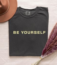 Introducing the "Comfort Colors Be Yourself" T-Shirt, a cozy and stylish way to remind yourself and others to embrace authenticity. Crafted from high-quality Comfort Colors fabric, this tee offers a relaxed fit with a timeless message: Be Yourself. Perfect for those who value comfort and confidence, this shirt is designed for easy, everyday wear while promoting self-love and positivity. Whether you're looking for a thoughtful gift or a personal wardrobe staple, this shirt will help you shine just as you are! key features Premium Comfort Colors fabric for a soft, lived-in feel Encouraging "Be Yourself" message for daily inspiration Durable and breathable for lasting comfort Available in multiple sizes and color options Perfect for casual outings, self-care days, or gifting someone special Women Shirt, Cute Woman, Be Yourself, Comfort Colors, Wardrobe Staples, Fabric Color, Self Love, Favorite Outfit, Graphic Tee