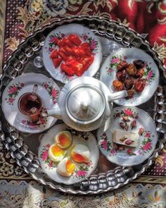 an overhead view of plates with food on them and saucers next to each other