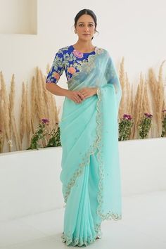 Aqua blue scallop trimmed saree with hand embroidery detailing. Paired with a royal blue padded silk blouse with fiza print, and detailed with hand embroidery. - Aza Fashions Designer Georgette Blouse With Embroidered Border, Bollywood Style Blouse With Embroidered Border For Receptions, Fitted Pre-draped Saree With Embroidered Border For Reception, Elegant Embroidered Border Blouse For Reception, Elegant Embroidered Blouse For Reception, Festival Blouse With Embroidered Border For Reception, Festival Embroidered Border Blouse For Reception, Festive Georgette Blouse With Embroidered Border, Wedding Georgette Blouse With Embroidered Border