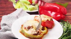 a person cutting into some food on a plate with a knife and fork in it