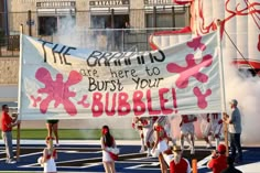 a group of cheerleaders holding up a banner with the words, life begins here to burst your bubble