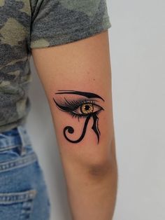 a woman's arm with an eye tattoo on it