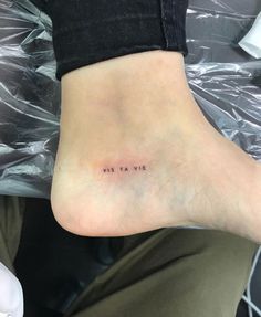 a person's foot with the word miss ta vie written on it in black ink