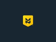 a yellow and black logo with the letter m in it's center on a dark background