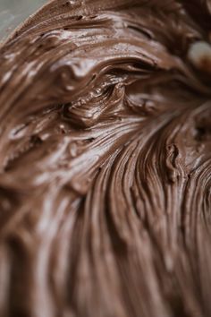 a close up view of chocolate frosting in a bowl