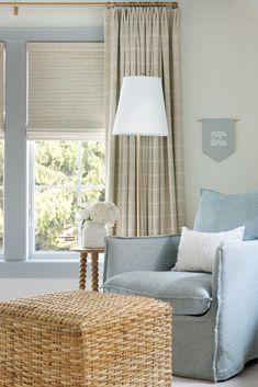 a living room filled with furniture next to a window covered in curtains and drapes