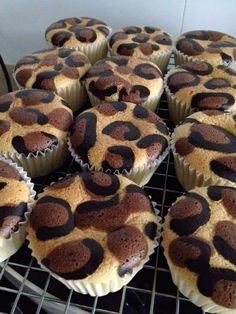 a bunch of cupcakes that are sitting on a cooling rack in the oven