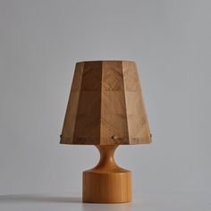 a wooden table lamp on a white surface