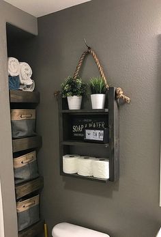 a bathroom with a toilet and shelves above it