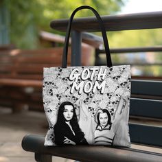 "WILL NOT RECEIVE BEFORE CHRISTMAS, WILL COME AFTER CHRISTMAS Introducing our exclusive \"Goth Mom\" tote bag featuring the iconic Lily Munster and Morticia Addams. Elevate your style and celebrate your gothic spirit with this bewitchingly tote bag. This practical, high-quality tote bag is available in three sizes provides comfort with style at the beach or out in town. Made from reliable materials, lasting for seasons. .: Made with 100% polyester, a medium-weight fabric (6.49 oz/yd² (200 g/m that is highly durable and perfect for everyday use.  .: All tote bags come with a non-woven laminate inside and are available in 3 sizes (1x large storage compartment)  .: Black cotton handles .: NB! Size tolerance 0.75\" (1.9 cm)) **PLEASE Be Aware Colors May Be Slightly Different in Shade As Shown* Black Themed Bag With Character Print, Themed Black Bag With Character Print, Goth Mom, Lily Munster, Mom Tote Bag, Morticia Addams, Purse Gift, Handbag Purse, Medium Weight