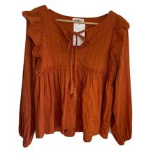 In Loom Long Sleeve Tunic Ruffle Blouse Casual Tassel Boho Rust Color Women Sz Small New With Tags - Nwt Pit To Pit- 18” Length- 22” Sleeves-25” Casual Vacation Blouse With Tassel Ties, Casual Blouse With Tassel Ties For Vacation, Fall V-neck Blouse With Tassels, Fall Tassel V-neck Blouse, Summer Bohemian Peasant Top With Tie Neck, Spring Vacation Blouse With Back Tassel Tie-up, Peasant Blouse With Ruffles For Beach, Peasant Style Ruffled Blouse For Beach, Bohemian Ruffled Peasant Top For Vacation