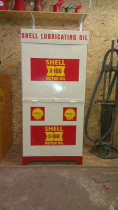 a shell lubricating oil dispenser next to a motor oil box