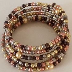 These are beautiful handmade  beaded bracelets which come in an assortment of widths.   Single strand to 8 strands.   Our single strand bracelets are great to wear with your other gold or silver bracelets to give them a touch of color to accent them. The price varies from $10.00 to $25.00. Please contact us for specific price or if you have any questions.  If you prefer a special color or style, we will take special orders. Gold Wrap Bracelet With Colorful Beads As Gift, Gold Wrap Bracelet With Colorful Beads, Multi-strand Bracelet With Gold Beads As Gift, Multi-strand Gold Beads Bracelet Gift, Gold Multi-strand Beaded Bracelet As Gift, Gold Hand-wrapped Beaded Bracelets, Adjustable Multi-strand Beaded Bracelet With Gold Beads, Adjustable Multi-strand Gold Beaded Bracelets, Gold Multi-strand Stackable Beaded Bracelets