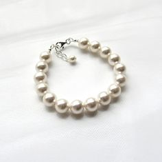 This chunky single strand pearl bracelet is perfect for all occasions!♥ All jewelry comes in a gift box and is ready to give at no additional cost! ♥Handmade with: ~Your choice of Swarovski white or ivory/cream pearls (10mm)~INCLUDES 1/2 INCH EXTENSION for adjustable sizing, embellished with pearl drop(Example ~ if ordering 7 inch size, bracelet will extend to 7.5 inches)------::BRACELET SIZE::How to measure - Wrap a measuring tape around the wristbone lightly. Add one of the following sizes lis Elegant Cream Pearl Bracelet As A Gift, Elegant Cream Pearl Bracelet As Gift, Elegant Cream Pearl Bracelet Gift, Cream Pearl Bracelet With Round Beads For Wedding, Cream Beaded Bracelets For Wedding With Round Beads, Cream Beaded Bracelets With Round Beads For Wedding, Cream Pearl Bracelet Gift, Gift Cream Pearl Bracelet, Classic Adjustable Cream Bracelets