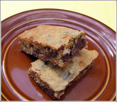 two pieces of dessert sitting on top of a brown plate