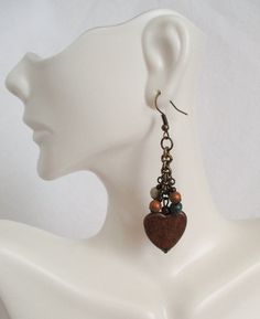 Wooden Heart Earrings 2.5" in length, made with colorful wooden beads, brass chain, and nickel-free brass ear hooks. These Wooden Heart Earrings ship to you in a gift box, ready to give as a present or to keep and store. Back To Beaded Earrings Unique Brown Beaded Earrings As Gift, Unique Brown Beaded Earrings For Gift, Bohemian Heart-shaped Beaded Earrings For Gifts, Bohemian Heart-shaped Beaded Earrings As Gift, Metal Heart Bead Earrings As Gift, Heart Beaded Metal Earrings As Gift, Heart Beads Metal Earrings As Gift, Heart-shaped Earrings With Dangling Beads For Gifts, Vintage Brown Beaded Earrings As Gift