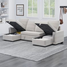 a living room with a sectional couch and storage underneath the sofa is shown in white leather