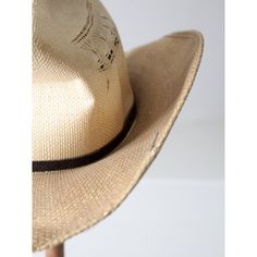 This vintage Rockmount Ranch Wear hat is as classic as they come. With a black hat band and crease, you can make a traditional western statement. The distressed look gives the straw hat a unique character, with darkening and subtle streaking of the tone. The style of hat is "Desert Wind."   MARKED SIZE:  7 3/8 MEASUREMENTS Circumference:  22.75"  ..  57.8 cm Brim:  3.75"  ..  9.5 cm Height:  5"  ..  12.7 cm Rustic Hat Band For Curved Brim In Natural Color, Rustic Short Brim Fedora For Kentucky Derby, Rustic Curved Brim Hat Bands In Natural Color, Adjustable Rustic Panama Hat With Curved Brim, Classic Curved Brim Sun Hat For Western-themed Events, Vintage Adjustable Fedora For Country Events, Adjustable Vintage Fedora For Country Events, Country Style Boater Hat For Rodeo With Curved Brim, Rustic Fedora With Short Brim For Rodeo