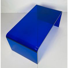 a blue table sitting on top of a white floor