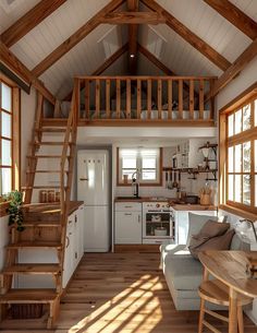 a living room and kitchen area in a small house with wood floors, white walls and ceiling