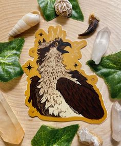 an image of a bird on a sticker surrounded by leaves and other things that are around it