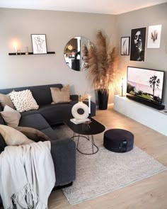 a living room filled with furniture and pictures on the wall