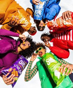 a group of people standing in a circle holding chips