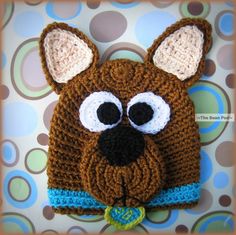 a crocheted brown dog hat with big eyes