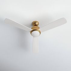 a white ceiling fan with a gold and white light on it's blade blades