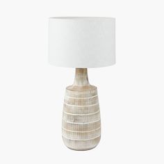 a table lamp with a white shade on it