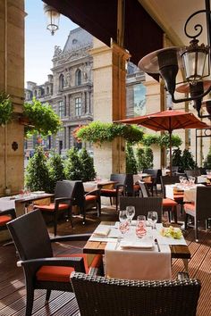 an outdoor dining area with tables and chairs