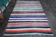 a multicolored striped rug is on the floor