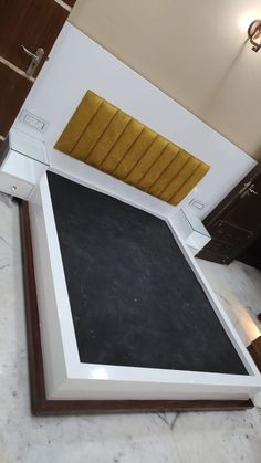 a black and white counter top in a kitchen with gold accents on the back wall