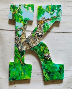 the letter k is made up of wood and painted with slotty's on it