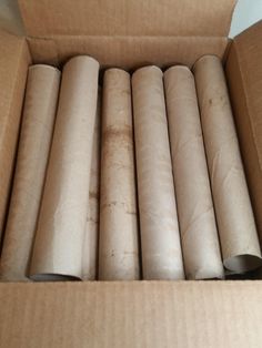 several rolls of toilet paper in a cardboard box