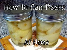 two jars filled with pickles sitting on top of a cutting board