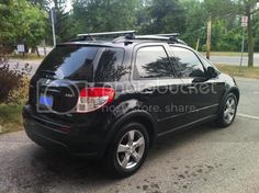 a black suv is parked on the side of the road