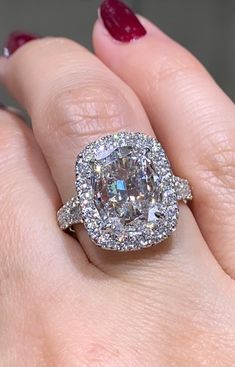 a woman's hand with a diamond ring on it